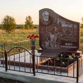 Гранитный памятник охотнику в форме арки с охотничьим трофеем